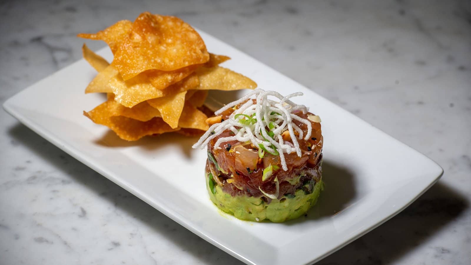 Crispy chips are served to scoop a tasty tombo tuna poke tower with diced avocado topped with the spicy, soy sauce-based marinated fish. (Jeremy Portje/ Marin Independent Journal)