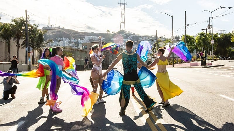 people dancing with colorful flags